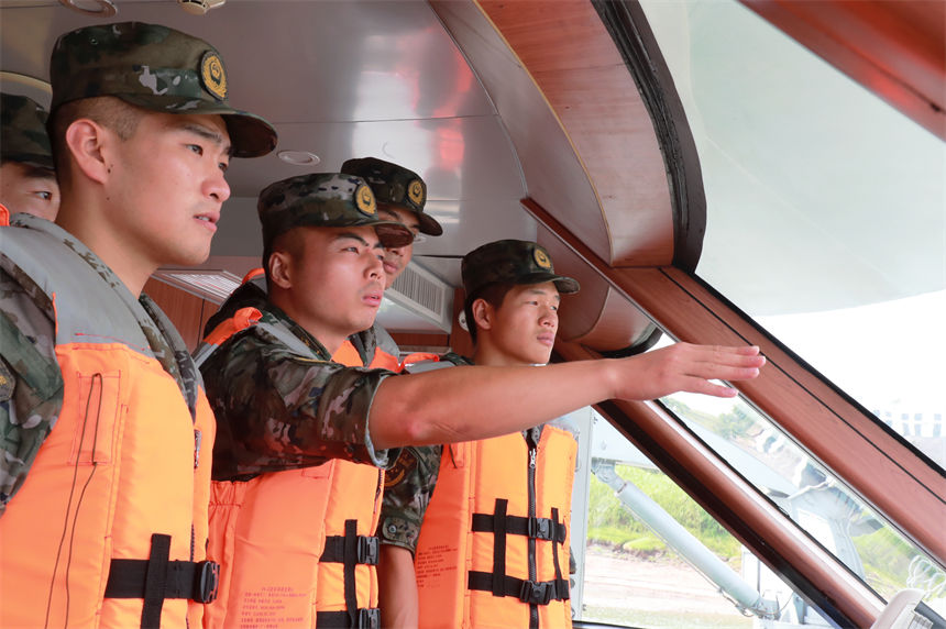 老兵為戰友講解船艇駕駛技巧。安宇梁攝