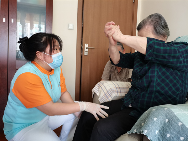 龍山街道社區養老服務中心護士長指導長者肢體康復訓練。龍山街道供圖