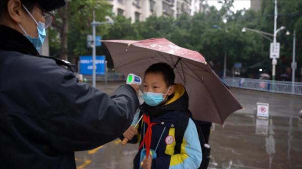 門衛對進校學生進行體溫檢測。楊安東攝