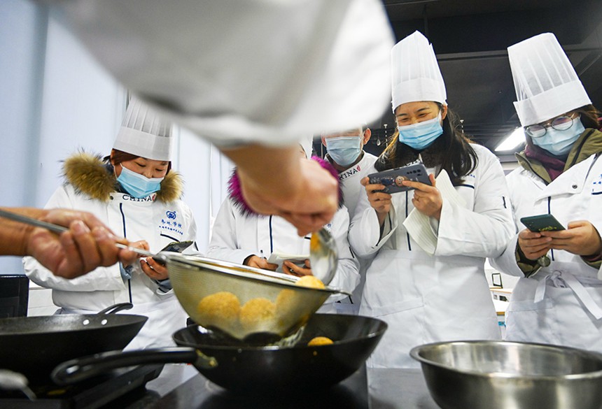 為幫助就業困難人員掌握一技之長，渝北區人力社保局開辦各類免費技能培訓班。圖為學員們正在老師指導下學習制作重慶小吃。(資料圖片）記者 萬難 攝/視覺重慶