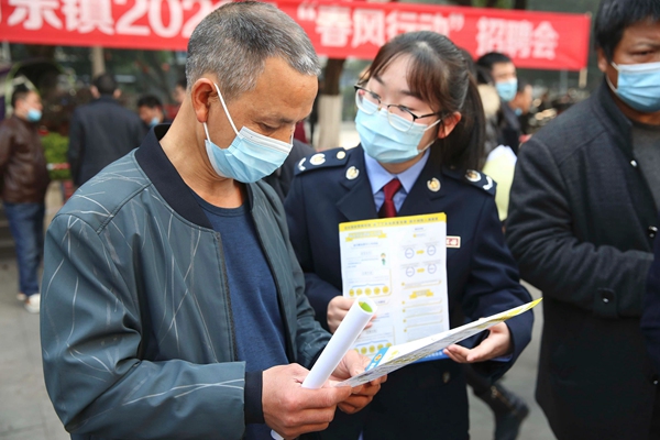 萬盛經開區稅務人員走進“春風行動”招聘會，向企業和求職人員宣傳稅收優惠政策。王僑攝