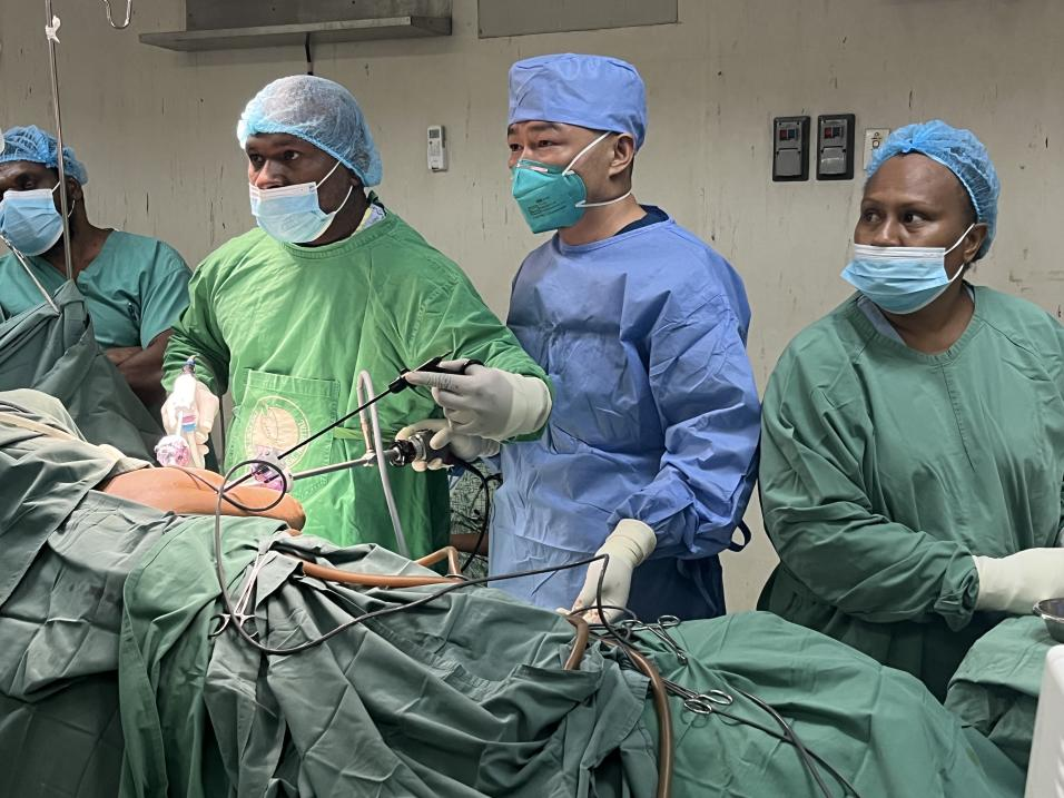 重慶醫生鮮鵬正在指導當地泌尿外科醫生Dr.Munguas主刀完成手術。受訪者供圖。