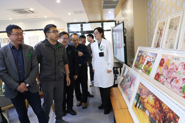 重慶市精神衛生中心康復科主任袁媛向參觀者介紹患者作品。重慶市精神衛生中心供圖