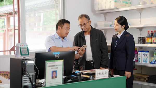 楊聰指導村民辦理相關業務。郵儲銀行重慶分行供圖
