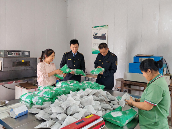 市場監管工作人員走訪艾草企業引導樹立品牌意識。銅梁區市場監管局供圖
