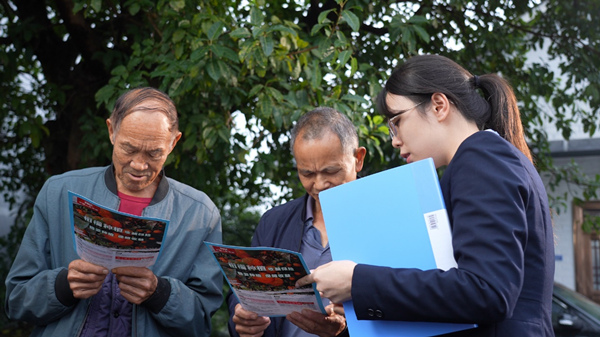 工作人員為農戶詳細講解農業保險政策。人保財險重慶分公司供圖