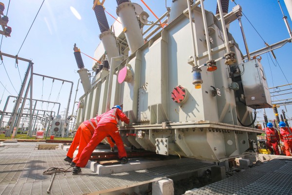 施工人員在220千伏田家變電站整體搬運2號新主變壓器。蔣佩攝