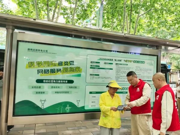 工作人員在公交站臺為市民宣傳科學用電知識。張強攝